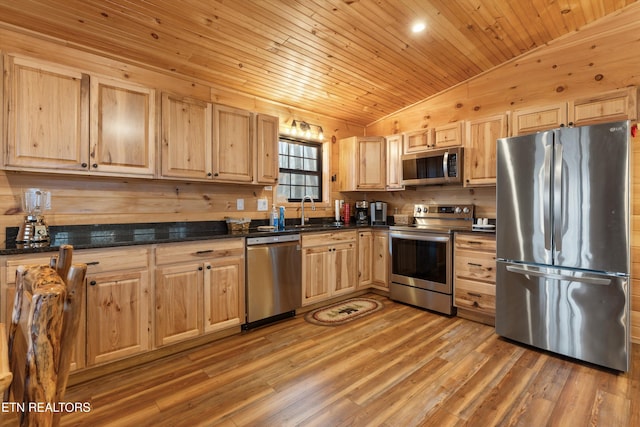 kitchen with sink, wood ceiling, hardwood / wood-style flooring, stainless steel appliances, and vaulted ceiling