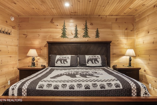 bedroom featuring wooden ceiling and wooden walls