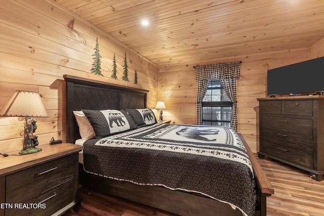 bedroom featuring wood ceiling, light hardwood / wood-style floors, and wood walls