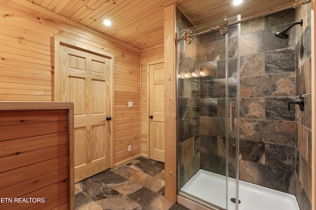 bathroom with wood walls, wooden ceiling, and walk in shower