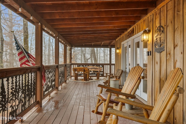 sunroom featuring beamed ceiling