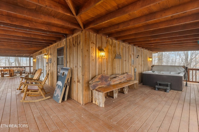 wooden deck with a hot tub