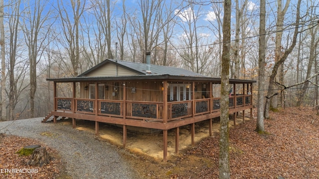 rear view of house featuring a sunroom