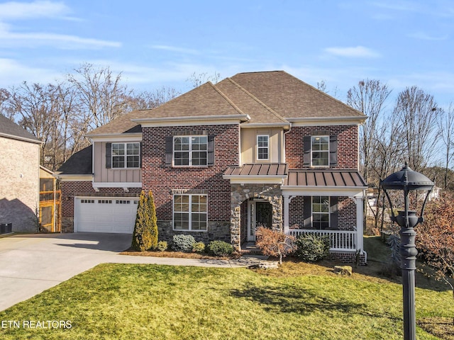 view of front of home with a garage, a porch, and a front lawn