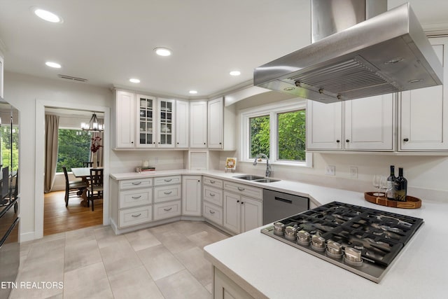 kitchen featuring sink, stainless steel appliances, white cabinets, and island exhaust hood