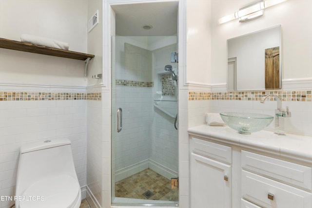 bathroom with vanity, tile walls, an enclosed shower, and toilet