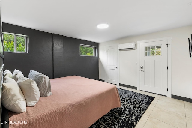 bedroom featuring a wall mounted air conditioner and light tile patterned floors