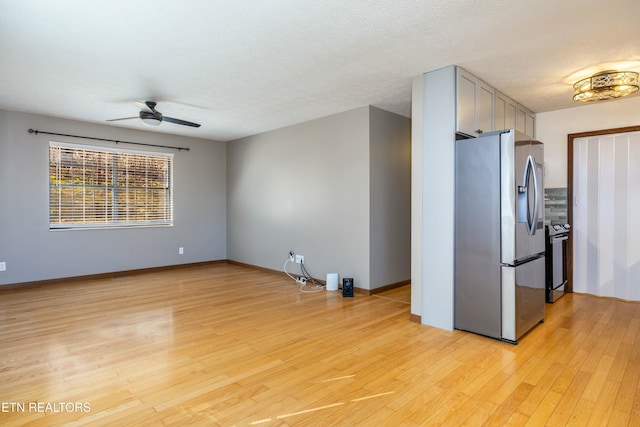 kitchen with ceiling fan, appliances with stainless steel finishes, a textured ceiling, and light wood-type flooring