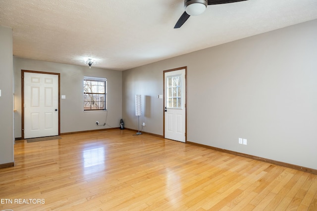 unfurnished room featuring ceiling fan, a textured ceiling, and light wood-type flooring