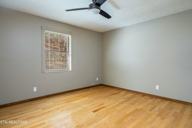 unfurnished room featuring ceiling fan, a textured ceiling, and light wood-type flooring