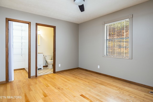 unfurnished bedroom with light hardwood / wood-style floors and ensuite bathroom