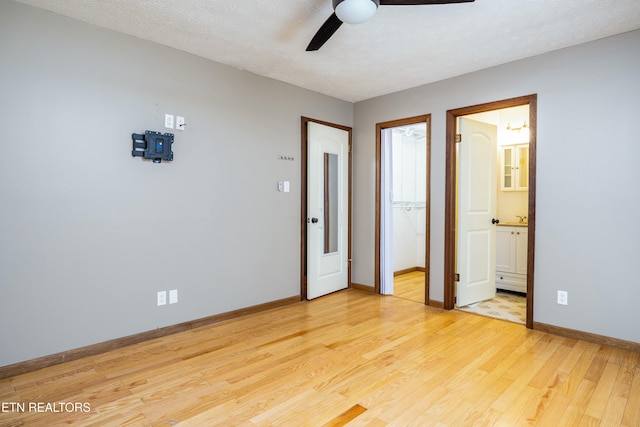 unfurnished bedroom with ensuite bath, light wood-type flooring, ceiling fan, a textured ceiling, and a closet