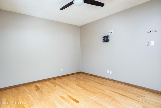 spare room with hardwood / wood-style flooring and ceiling fan