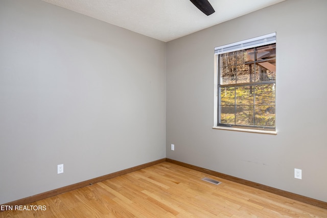 spare room with light hardwood / wood-style flooring and ceiling fan