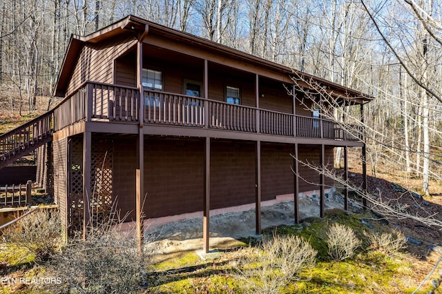 back of property featuring a wooden deck