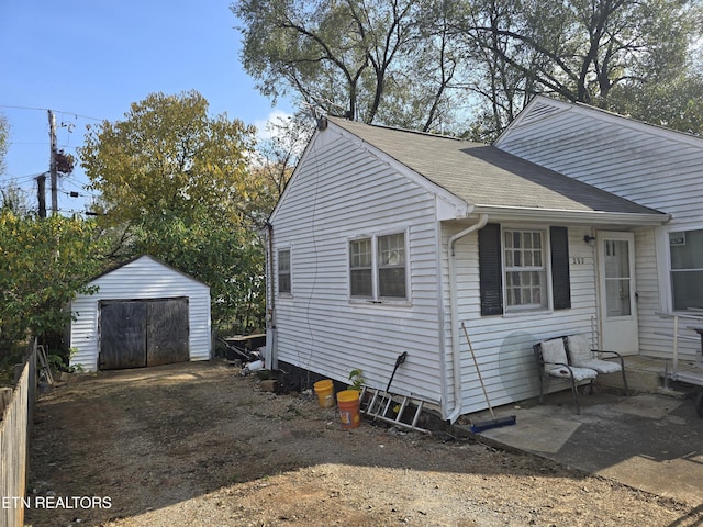 view of side of property with a storage unit