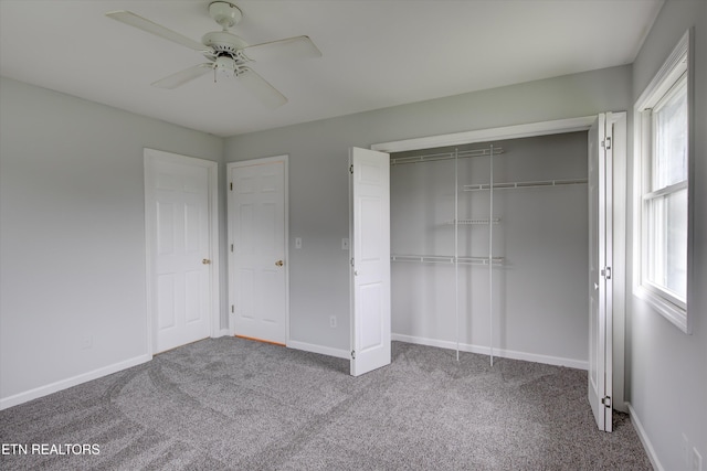 unfurnished bedroom featuring carpet flooring, ceiling fan, and a closet