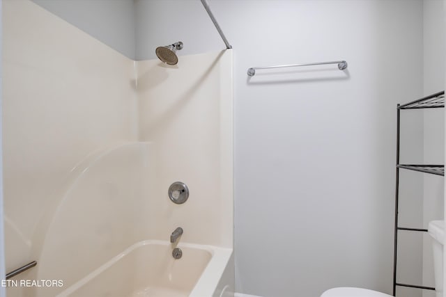 bathroom with toilet and washtub / shower combination