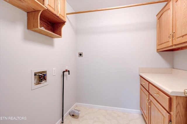 clothes washing area featuring hookup for a washing machine, electric dryer hookup, and cabinets