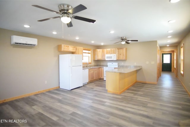 kitchen with light brown cabinetry, a wall mounted air conditioner, light hardwood / wood-style flooring, kitchen peninsula, and white appliances