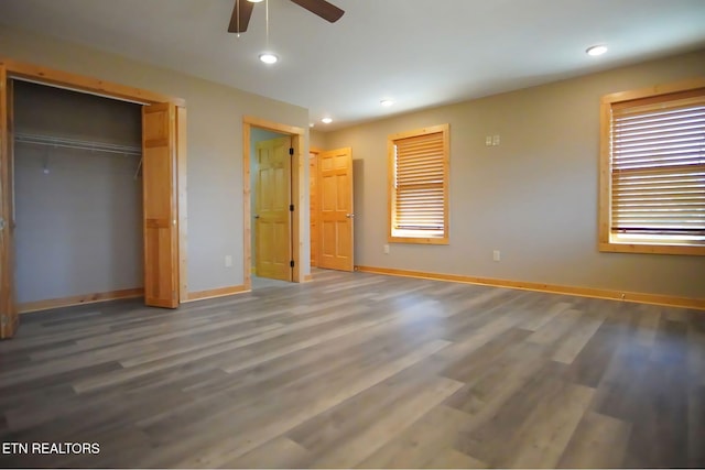 unfurnished bedroom with wood-type flooring, a closet, and ceiling fan