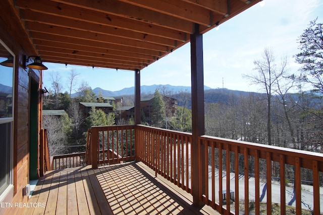 wooden deck featuring a mountain view