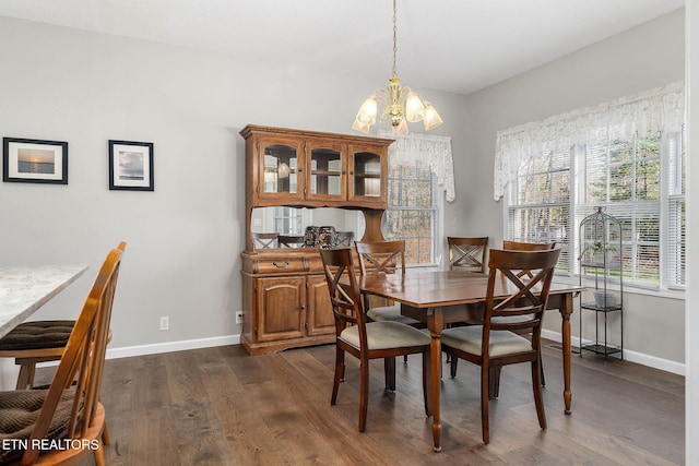 dining room featuring dark hardwood / wood-style flooring and an inviting chandelier