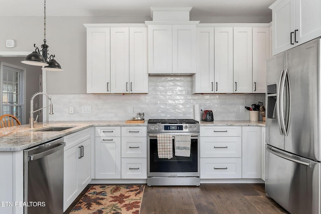 kitchen featuring white cabinetry, appliances with stainless steel finishes, and pendant lighting