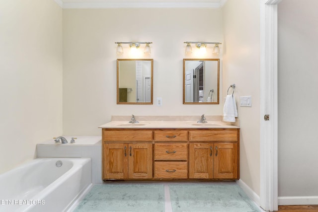 bathroom featuring crown molding, vanity, and a bathing tub