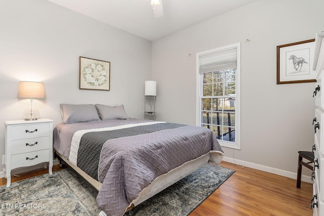 bedroom with hardwood / wood-style floors and ceiling fan