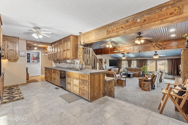 kitchen featuring sink, backsplash, black dishwasher, light carpet, and beamed ceiling