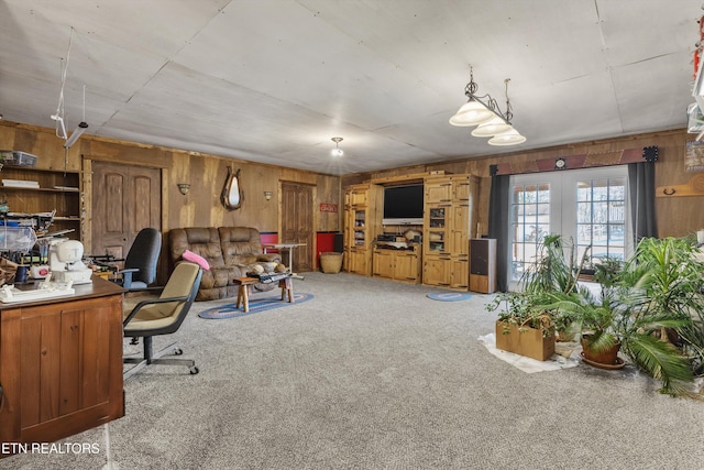 office featuring french doors, wooden walls, and carpet floors