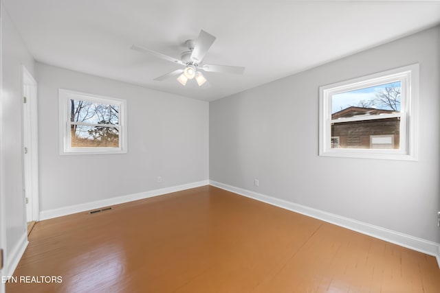 spare room with wood-type flooring and ceiling fan