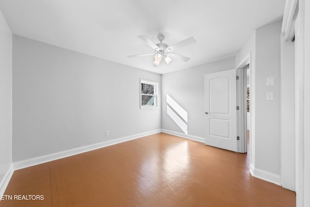 empty room with hardwood / wood-style flooring and ceiling fan