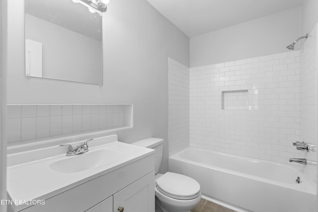 full bathroom featuring vanity, toilet, and tiled shower / bath combo