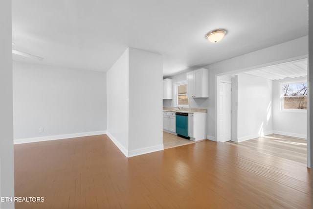 unfurnished living room with sink and light hardwood / wood-style floors