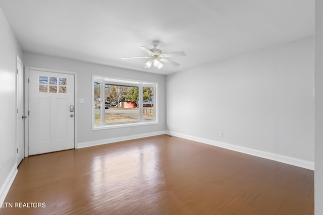 unfurnished room featuring ceiling fan and dark hardwood / wood-style floors