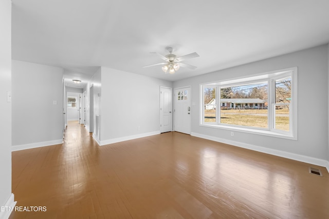 spare room with hardwood / wood-style flooring and ceiling fan