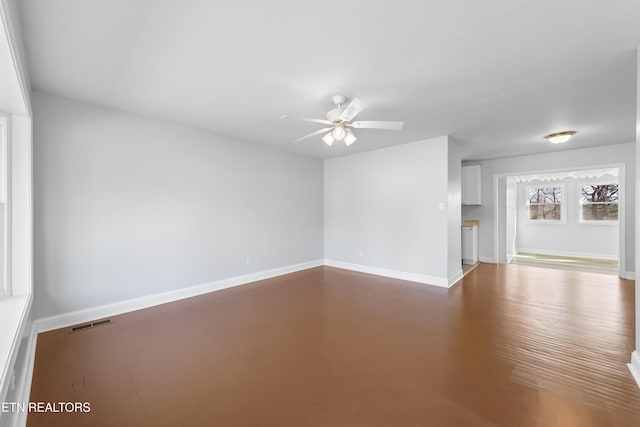 unfurnished living room with ceiling fan