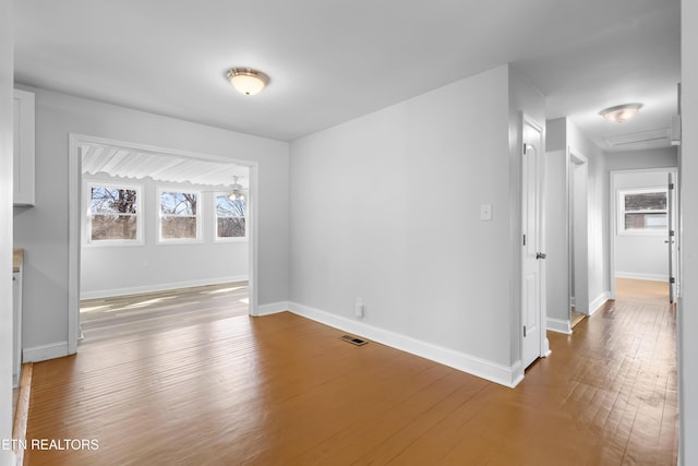 unfurnished room with plenty of natural light and hardwood / wood-style floors