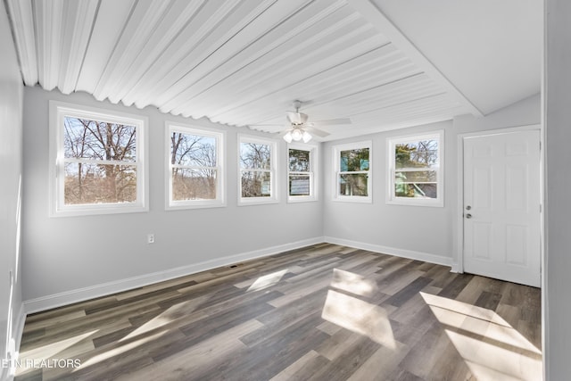 unfurnished sunroom featuring ceiling fan and a healthy amount of sunlight