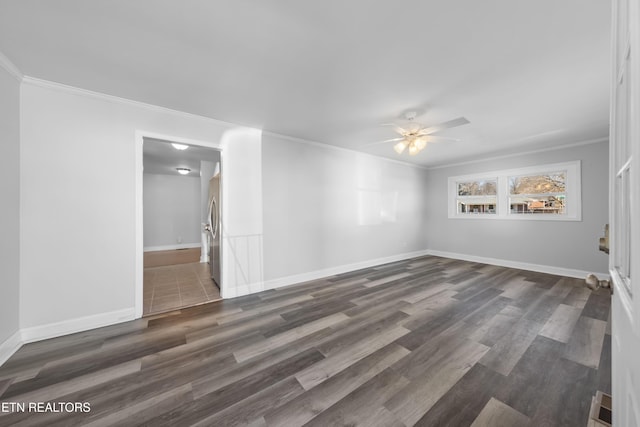 spare room featuring ornamental molding, dark wood-type flooring, and ceiling fan