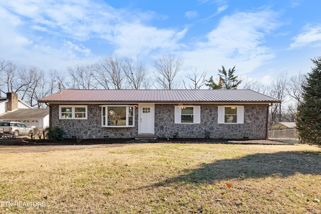 ranch-style house featuring a garage and a front lawn