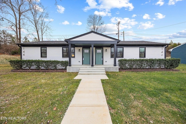 ranch-style house featuring covered porch and a front lawn