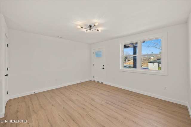 unfurnished room with light hardwood / wood-style flooring