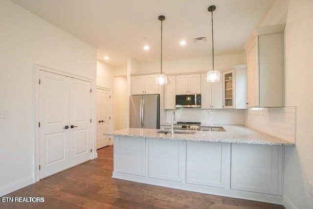 kitchen featuring white cabinetry, sink, light stone counters, kitchen peninsula, and stainless steel appliances