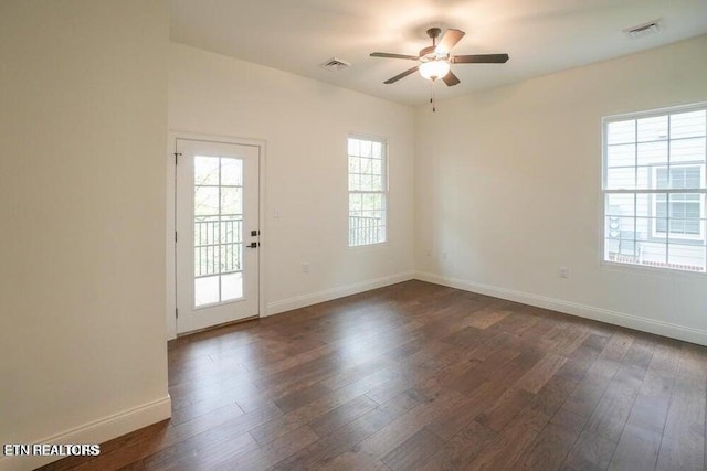 empty room with dark wood-type flooring and ceiling fan