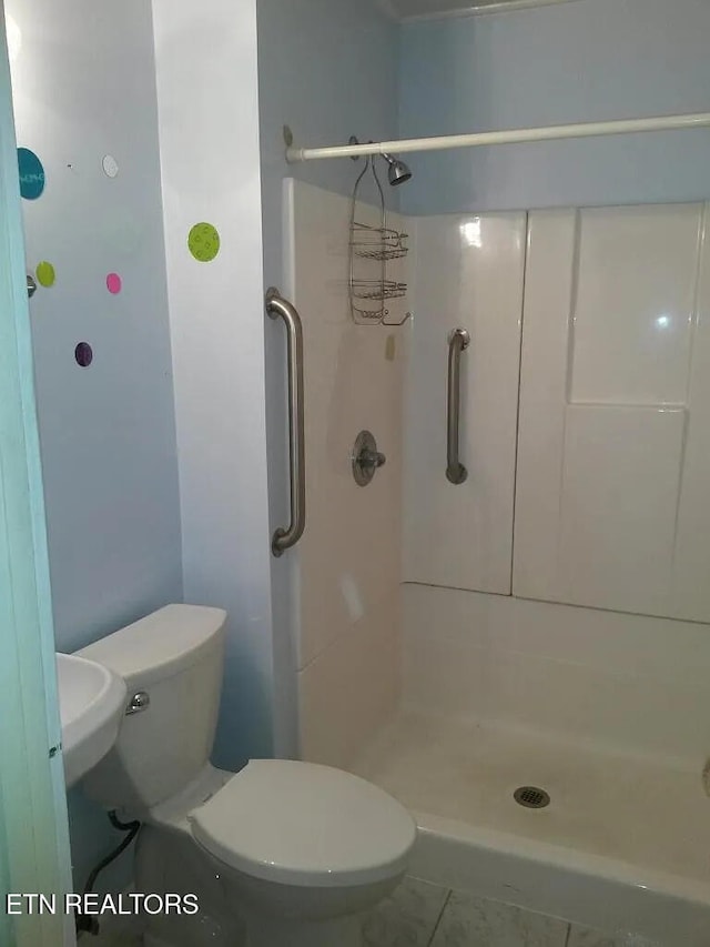 bathroom featuring toilet and a shower