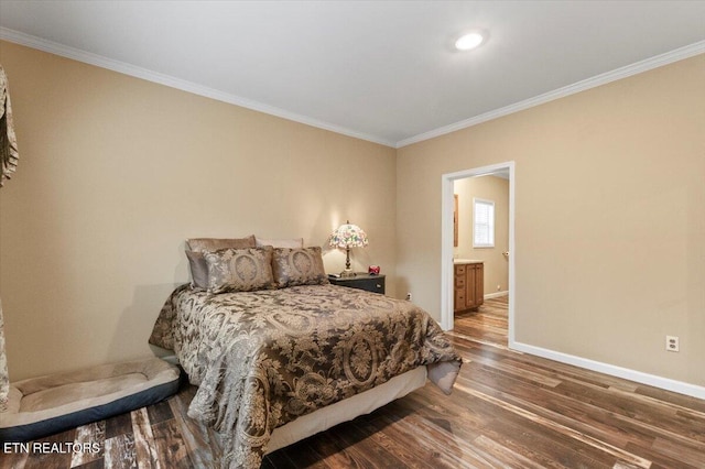 bedroom featuring hardwood / wood-style flooring, ensuite bath, and ornamental molding