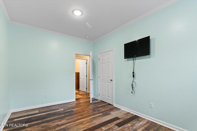 unfurnished bedroom with ornamental molding and dark hardwood / wood-style flooring